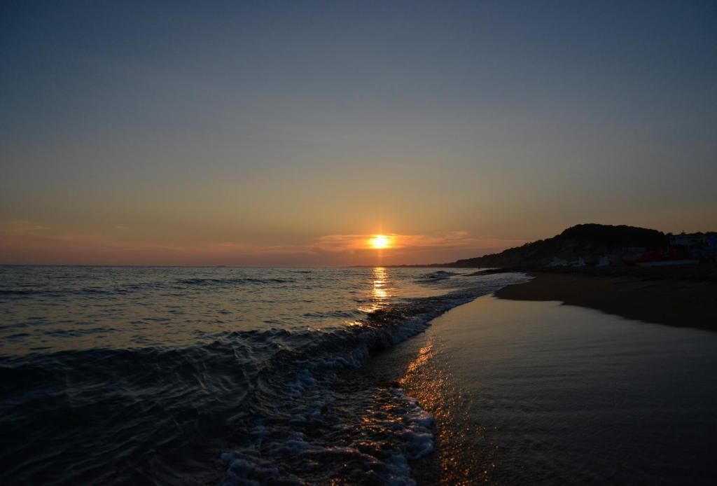 Sunset over the sea at Marathias beach, South Corfu